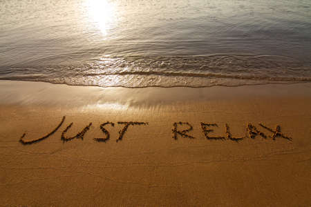 The inscription on sand near a sea edge: \\\\\\\"Just relax\\\\\\\"の写真素材