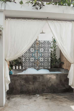 Eco hotel with pool in Vietnam with bamboo walls. Stone bathroom with the foam. Eco style bathroom...