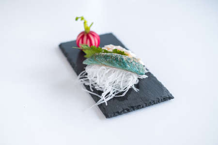 Decorated sashimi on black tray in Japanese restaurant. Perfectly served sushi in the restaurant. Japanese traditional food. Photo for the menu.の写真素材