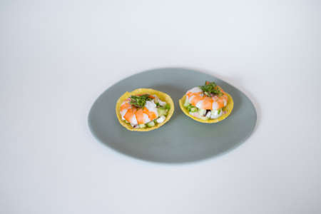 Asian style shrimp tartlets on white plate on white background. Close up, photo for the menu, tartlets with prawns, isolated on whiteの写真素材