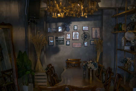 Eco cafe design in brown. Chandeliers made of rope. Antique items on the wall. Solid wood furniture....