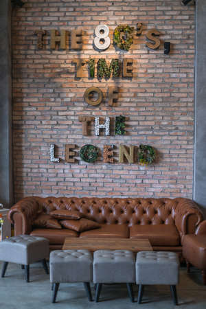 Eco cafe design in brown colours. Decorative inscription on a brick wall. The 80s, time of the legends. Coffee shop interior. High quality photoの写真素材