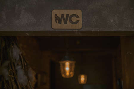 Toilet sign in the bar. Wooden WC sign in coffee shop. High quality photoの写真素材
