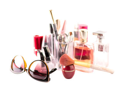 Cosmetic kit, cosmetics items, brush and glasses in the foregroundの写真素材