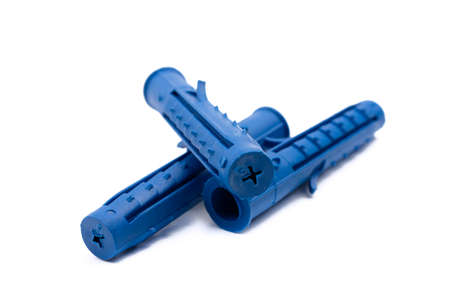 several plastic blue dowel screws on a white isolated background close-upの写真素材