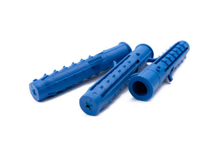 several plastic blue dowel screws on a white isolated background close-upの写真素材
