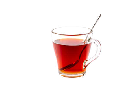 A Cup of tea with a spoon inside on a white isolated backgroundの写真素材