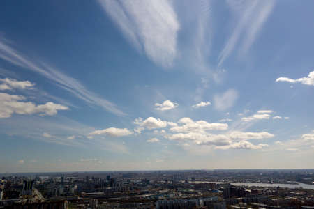Clouds in the blue sky wih forest under them at Novosibirsk, Russia. Forest and skyline.