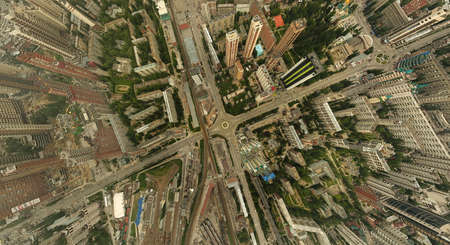 Aerial view of square in the city with roundabout traffic, streets and  and a lot of tall buildings with green treesの写真素材
