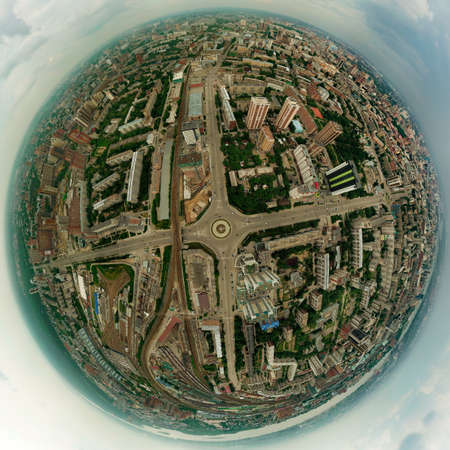 Aerial view of square in the city with roundabout traffic, streets and buildings with green trees with railways. Panoramc 360 degreesの写真素材