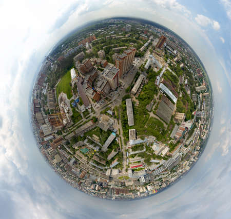 Aerial view of old and new russian buildings in green area in the city with a lot of cars. Panoramic 360 degrees wth skyscrapers and gray clouds.の写真素材