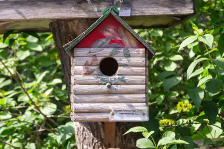 A wooden birdhouse made by children with their own hands for the exhibition in which the birds live,...