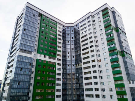 Aerial view of a tall skyscraper in green color in the form f a coner