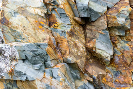 Background texture of a gray brown stone on the rock of the mountain discovered during...