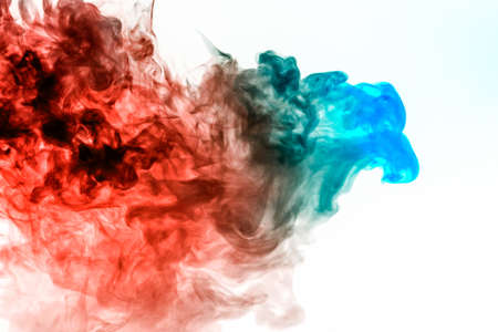 A multi-colored pattern of green and red smoke of a mystical shape in the form of a face and a ghost's head or a strange creature on a white isolated background. Abstract pattern in of waves and steamの写真素材