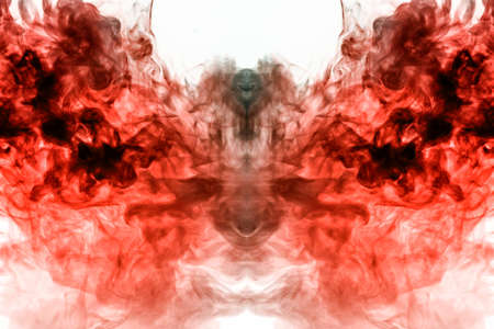 A multi-colored pattern of red smoke of a mystical shape in the form of a face and a ghost's head or...