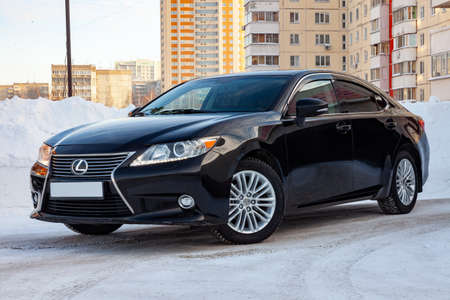 Novosibirsk, Russia - 12.01.2018: Black Lexus ES250 2014 release with an engine of 2.5 liters front view on the car parking with snow background.のeditorial素材