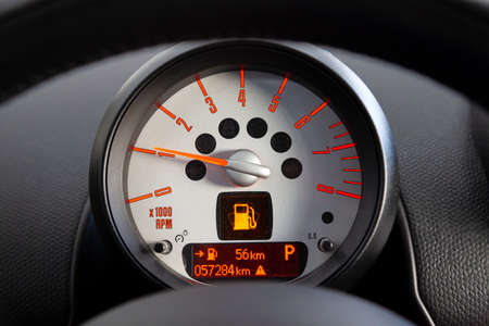 Closeup of the included backlit sensor onboard computer tachometer with red arrow and orange numbers...