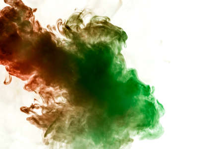 Background of dark green and red wavy smoke on a white isolated ground. Abstract pattern of steam from vape.の写真素材