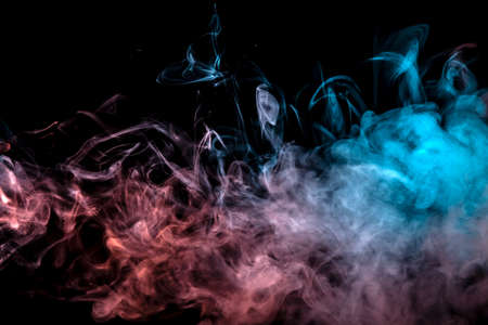 Translucent smoke rising to the top, illuminated by light on a dark background, multi-colored: blue, pink and grey, evaporating in waves exhaled from the wape.の写真素材