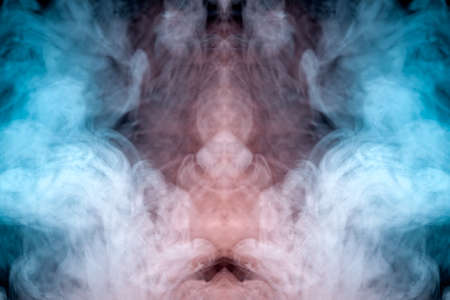 A misty pillar of smoke against a dark background of blue and pink is worn into a mystical image, exhaled from a vape electronic cigarette. T-shirt print.の写真素材