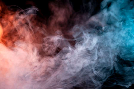 Multicolored pattern of the smoke of the pink, blue and red colors of the mystical shape on a white isolated background. Abstract pattern in the form of waves and steam. T-shirt print.の写真素材