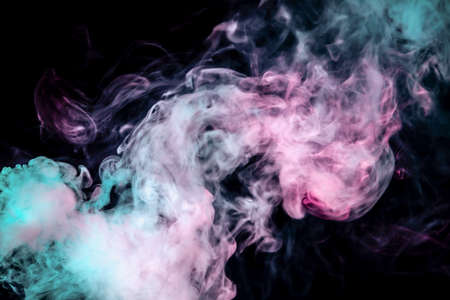 The beautiful color combination of blue, pink and violet hues from the substance is smoke, on a black background resembling the Milky Way for t-shirt print.の写真素材