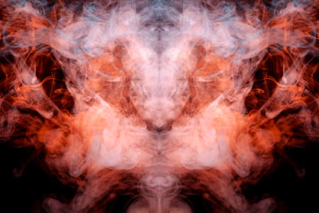 A mystical pattern of colored smoke of red and white in the shape of a ghost's face with fangs...