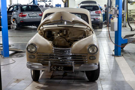 Novosibirsk, Russia - 01.30.19: Russian classic vintage car gaz m20 pobeda part of the history in a repair shop in good condition in a disassembled condition with the engine and hood removedのeditorial素材