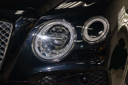 Novosibirsk, Russia - 08.01.18: Front headlamp of luxury very expensive new black Bentley Bentay car...
