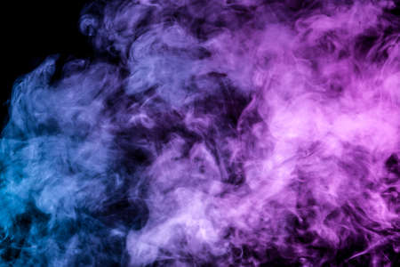 Translucent, thick smoke, illuminated by light against a dark background, divided into three colors: blue, green, pink and purple, burns out, evaporating from a steam of vape for print on t-shirtの写真素材