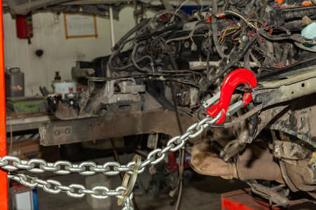 A broken car with a violation of geometry is on the stocks for leveling and repair in the workshop...