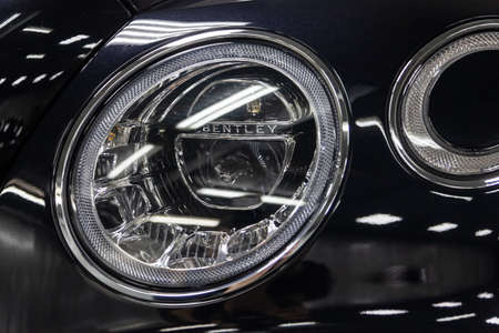 Novosibirsk, Russia - 08.01.18: Front headlamp of luxury very expensive new black Bentley Bentay car...