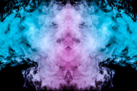 A multi-colored pattern of pink and blue smoke of a mystical shape in the form of a ghost's head or a strange creature on a black isolated background. Abstract pattern in of waves and steam.の写真素材