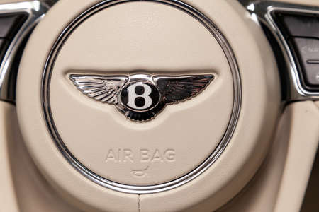 Novosibirsk, Russia - 08.01.18: Interior view with emblem on steering wheel of luxury very expensive new black Bentley Bentayga car stands in the washing box waiting for repair in auto serviceのeditorial素材