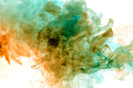 Colorful steam exhaled from the vape with a smooth transition of color molecules from yellow to blue on a white background like a collision of two jets of smoke.の写真素材