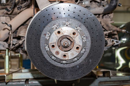 Ceramic brake disc from a perforated vehicle with a floating mounting system mounted on the hub of...