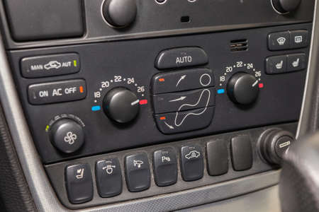 The central control console on the panel inside the car close-up with climate control and audio...