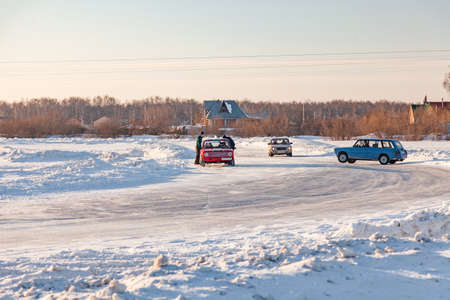 Novosibirsk, Russia - 02.02.2019: Old Russian cars Lada 2101 and 2104 prepared for racing drive on the ice on a frozen lake, drifting and moving in a skidder in a turn on a specially cleared trackのeditorial素材
