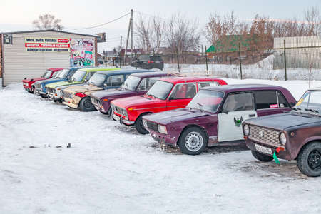 Novosibirsk, Russia - 02.02.2019: Old Russian cars Lada 2101 and 2104 prepared for racing standing on parking and waiting for  drifting and moving in a skidder in a turn on a specially cleared trackのeditorial素材