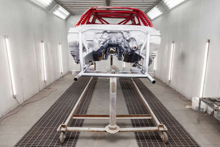 Painting in red and black color of the inside of the frame of the car disassembled after the accident in the workshop for body repair and tuning of vehiclesの写真素材