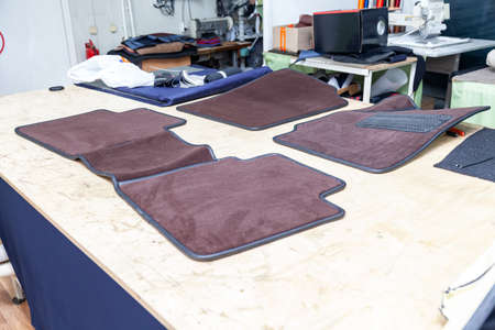 Car 3D handmade floor mats of brown color from wool for front and rear passengers of a vehicle in an...