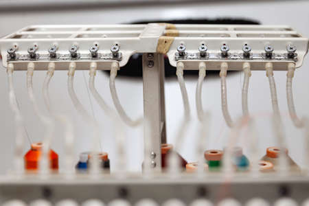 White thread guide in industrial sewing machine for embroidery of paintings and logos with threads...