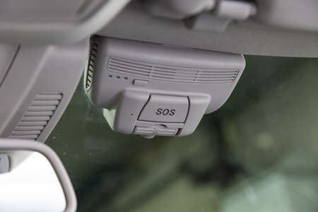 SOS button with JPS system to call the rescue service, police and ambulance on the windshield of the...