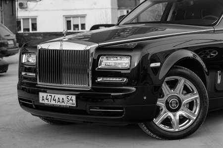 Novosibirsk, Russia - 04.11.2019: Front view of new a very expensive luxury Rolls Royce Phantom car, a long black limousine, model outdoors, prepared for sale in black and white colorのeditorial素材