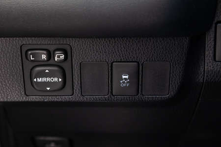 The buttons for controlling the mirrors electric drive on the center console of the instrument panel...