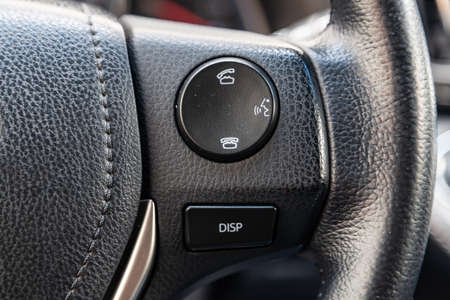 Phone control buttons on the steering wheel of a car close-up, the system hands-free gadget for...