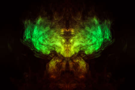 Abstract image of smoke of different green, yellow, orange and red colors in the form of horror in...