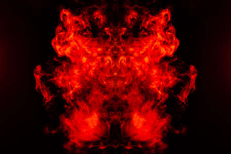 Smoke of different orange and red colors in the form of horror in the shape of the head, face and...