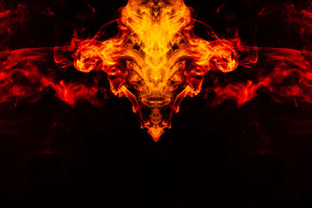 Smoke of different orange and red colors in the form of horror in the shape of the head, face and...